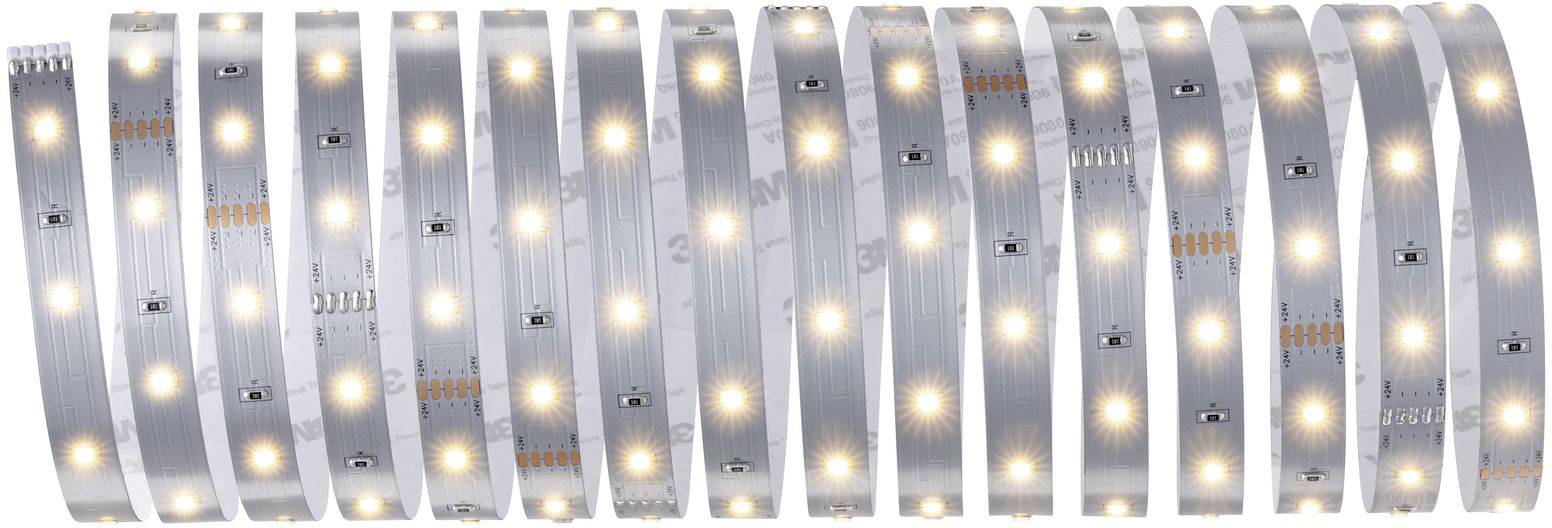 A coiled LED strip with warm white illuminating LEDs, mounted on a reflective strip, shows uniform illumination.