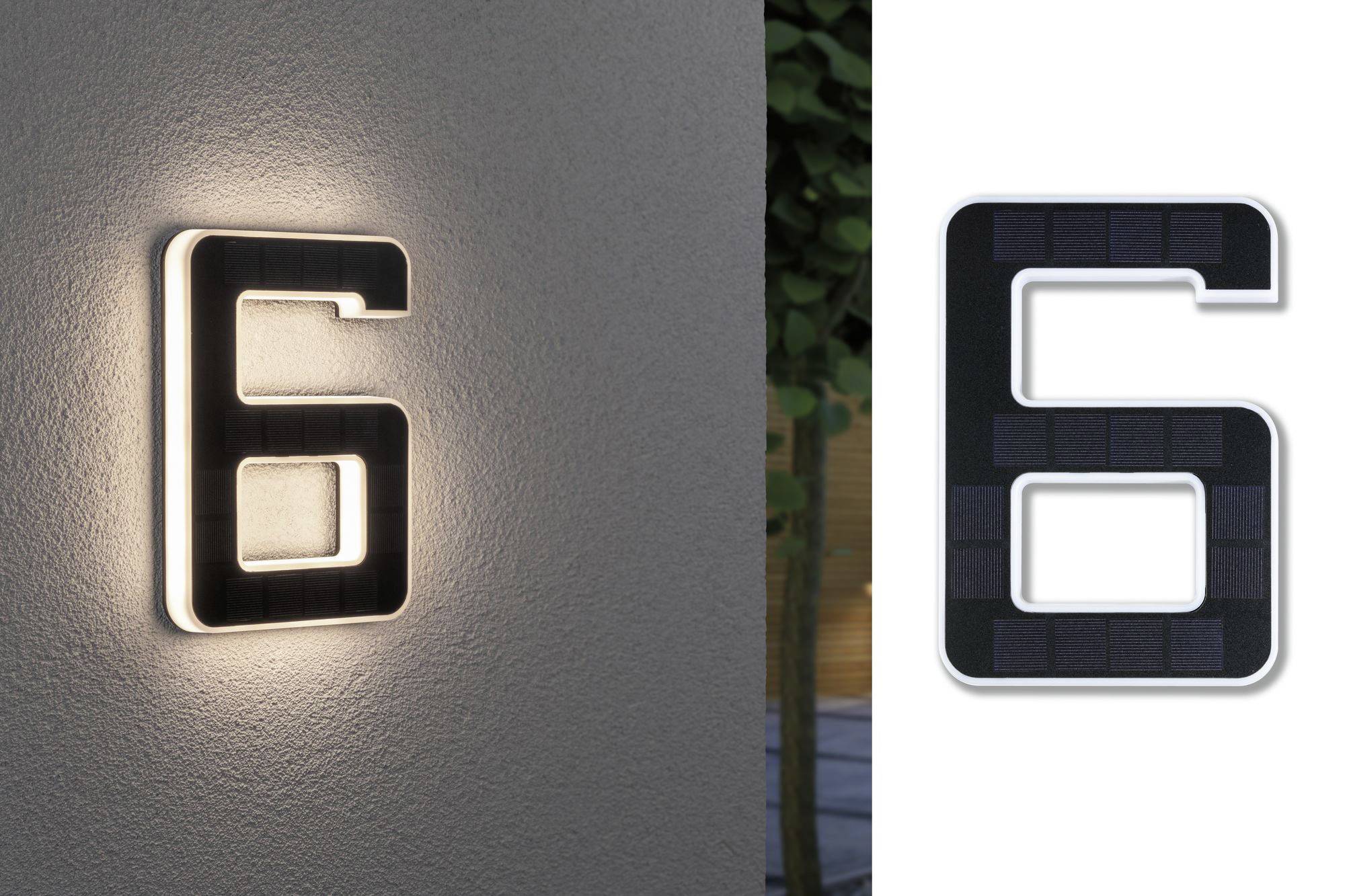 Illuminated house number '6' on a wall at night, with the same digit to the right in daylight.