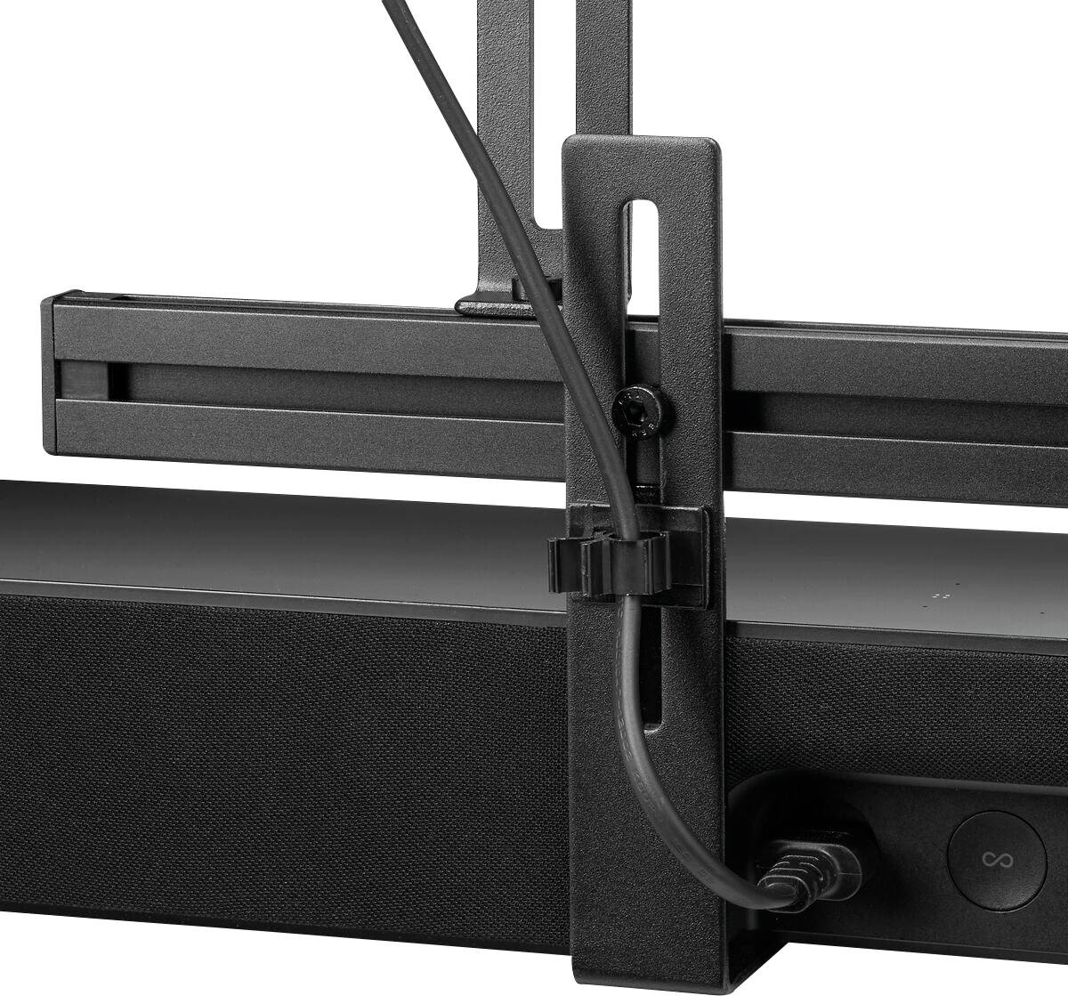 A television mounted on a wall bracket, with a black soundbar positioned underneath. Cables are secured to the mounting bracket.