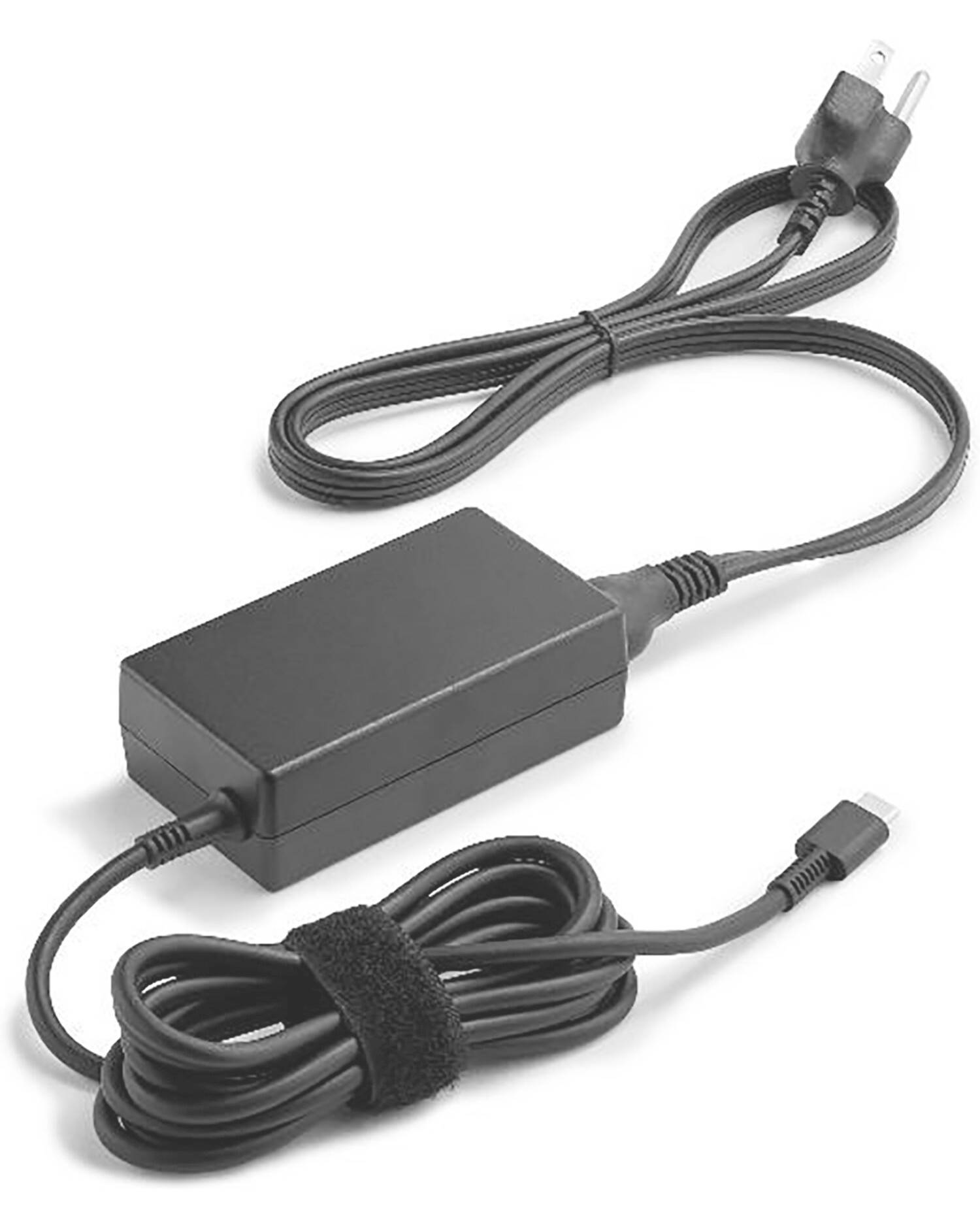 A black laptop charger with a long cable and plug, coiled and secured with a velcro strap.
