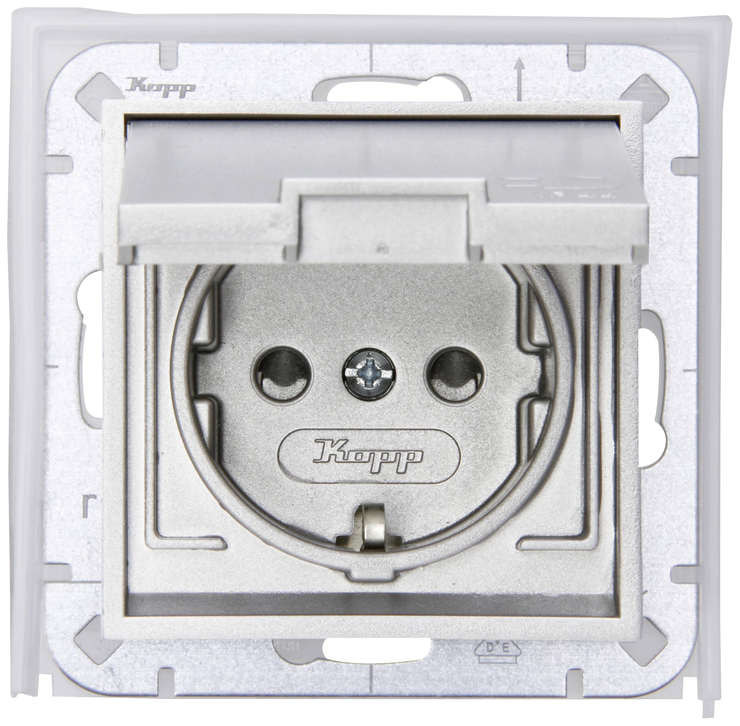 White socket with hinged cover, brand Kopp. Visible is the round socket slot with two holes and an earthing screw.