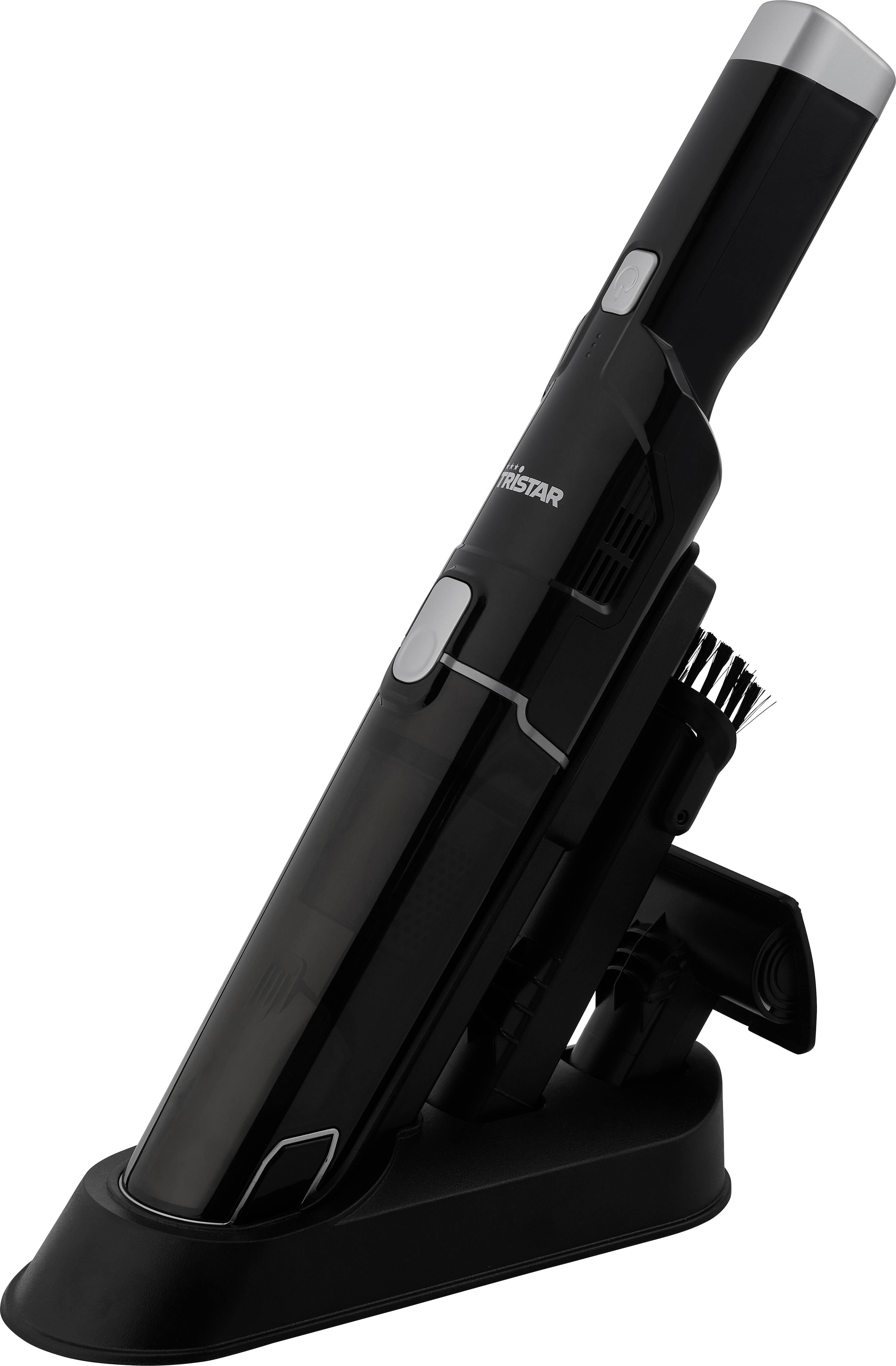 Black handheld vacuum cleaner on charging station, including brush attachment.