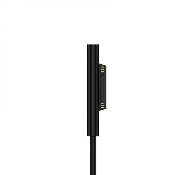 A black, sleek charger that is positioned vertically, with a magnetic connector for electronic devices.
