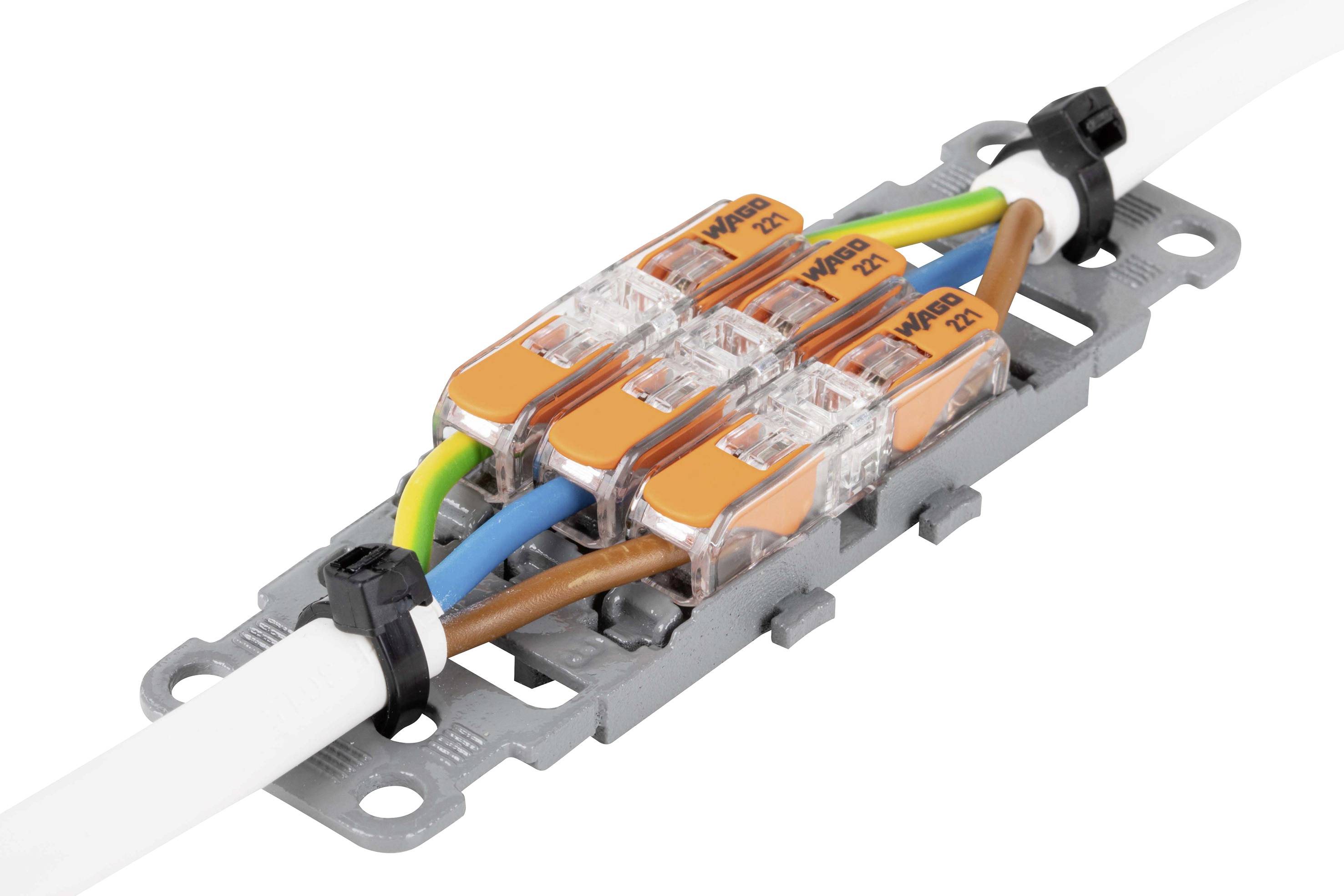 Illustrated is an electrical connection with transparent terminals connecting colourful cables (green-yellow, blue, brown) to one another.