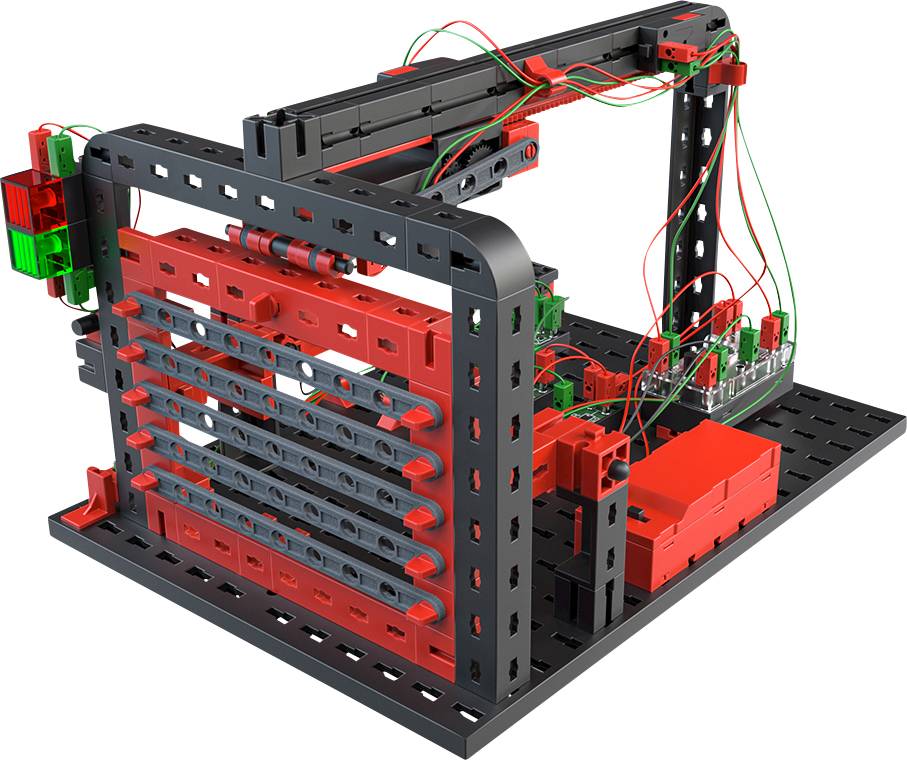 A red and black robot kit with visible cables, mounted on a perforated plate, displays an experimental structure.