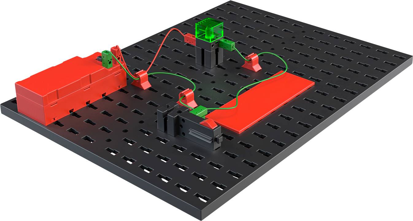Prototype breadboard with battery compartment on the left, connected to LED module and switch in the centre. Wire connections in green and red.