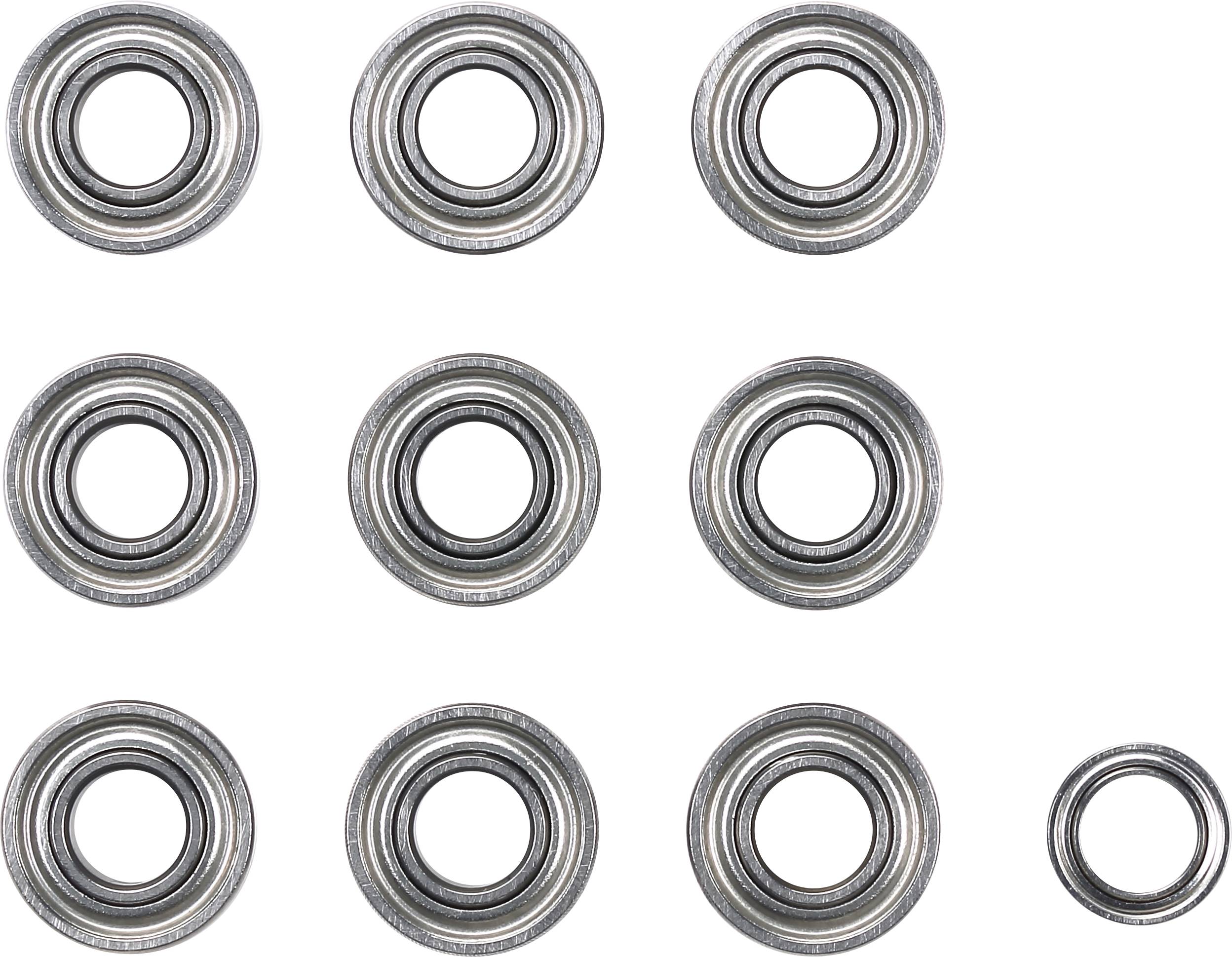 Nine circular metal bearings are arranged on a light background, with one bearing slightly smaller positioned bottom right.