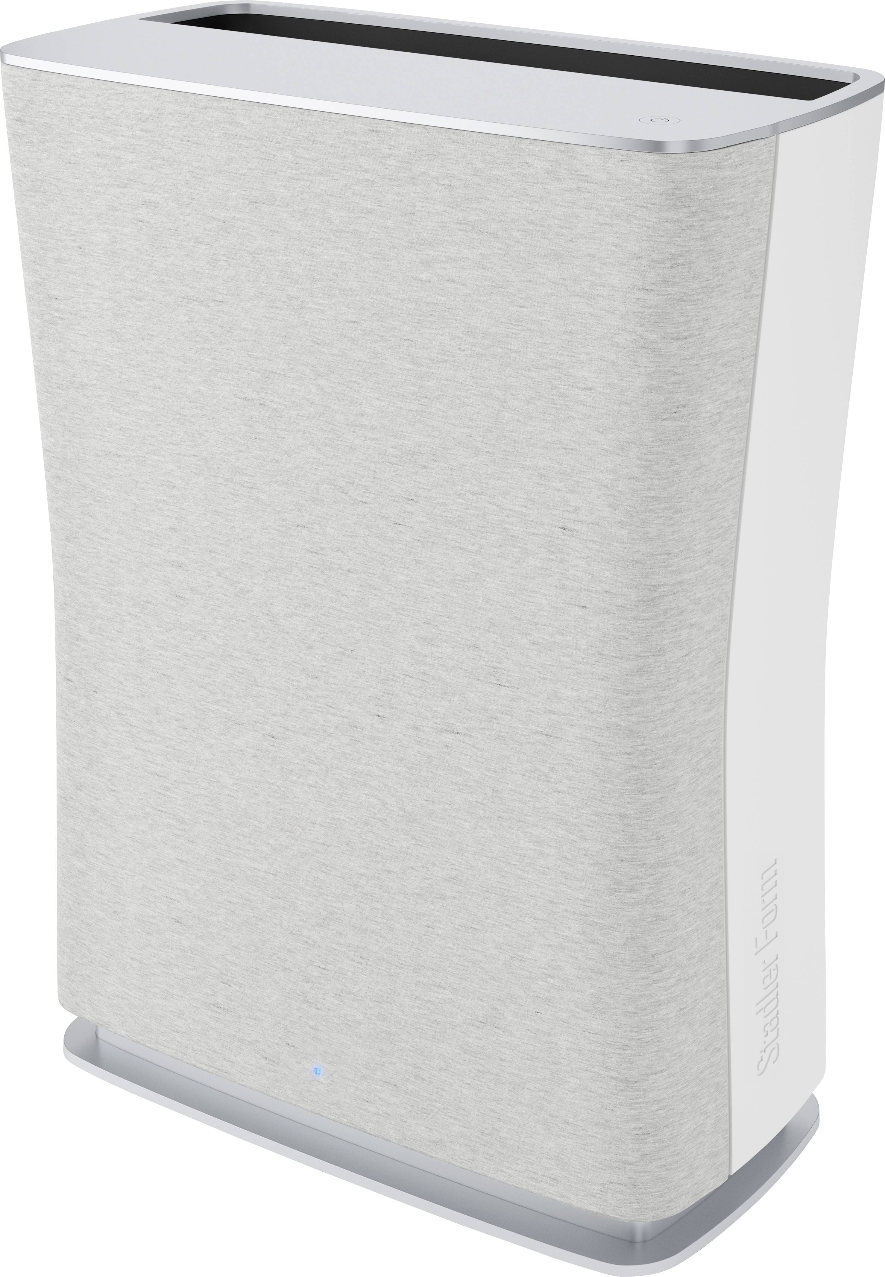 A rectangular air purifier with a grey fabric surface and rounded edges stands upright. A small blue light illuminates at the bottom.