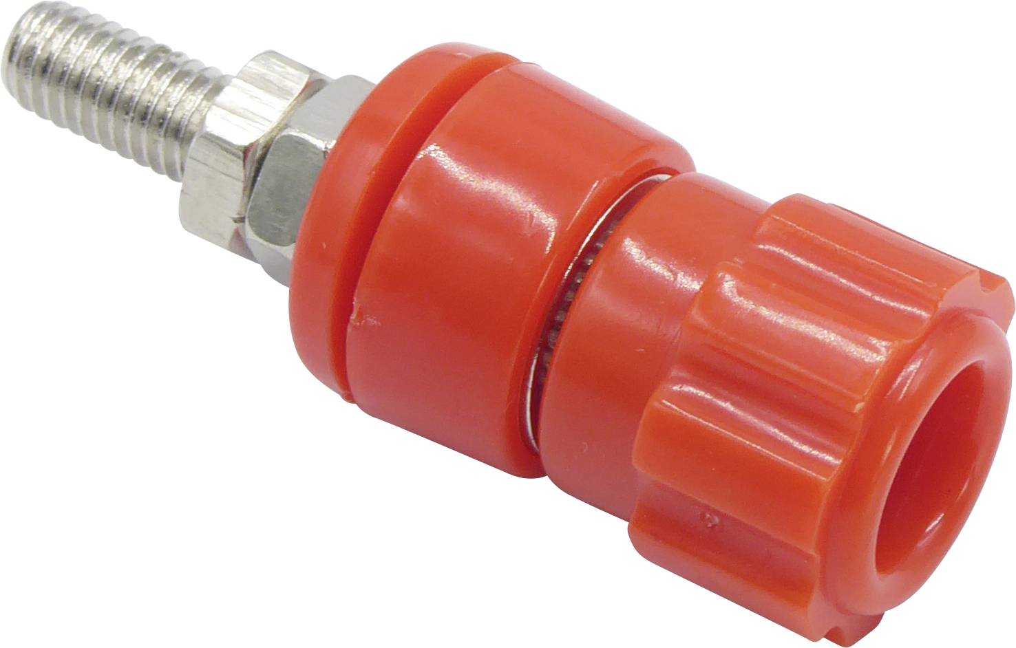 Red plastic fittings with metal threading, likely part of a garden irrigation system.