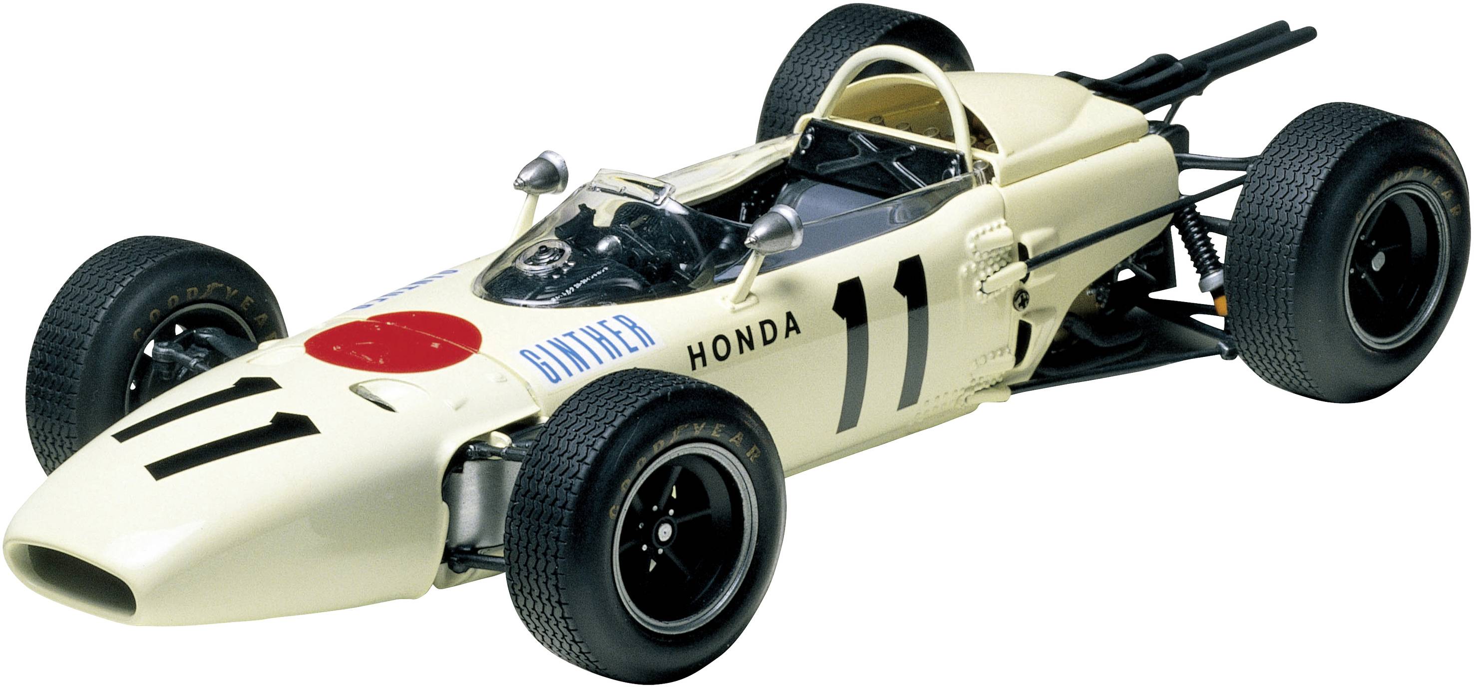 A classic racing car model in white with a black number '11' and red accents on the bonnet, against a light background.