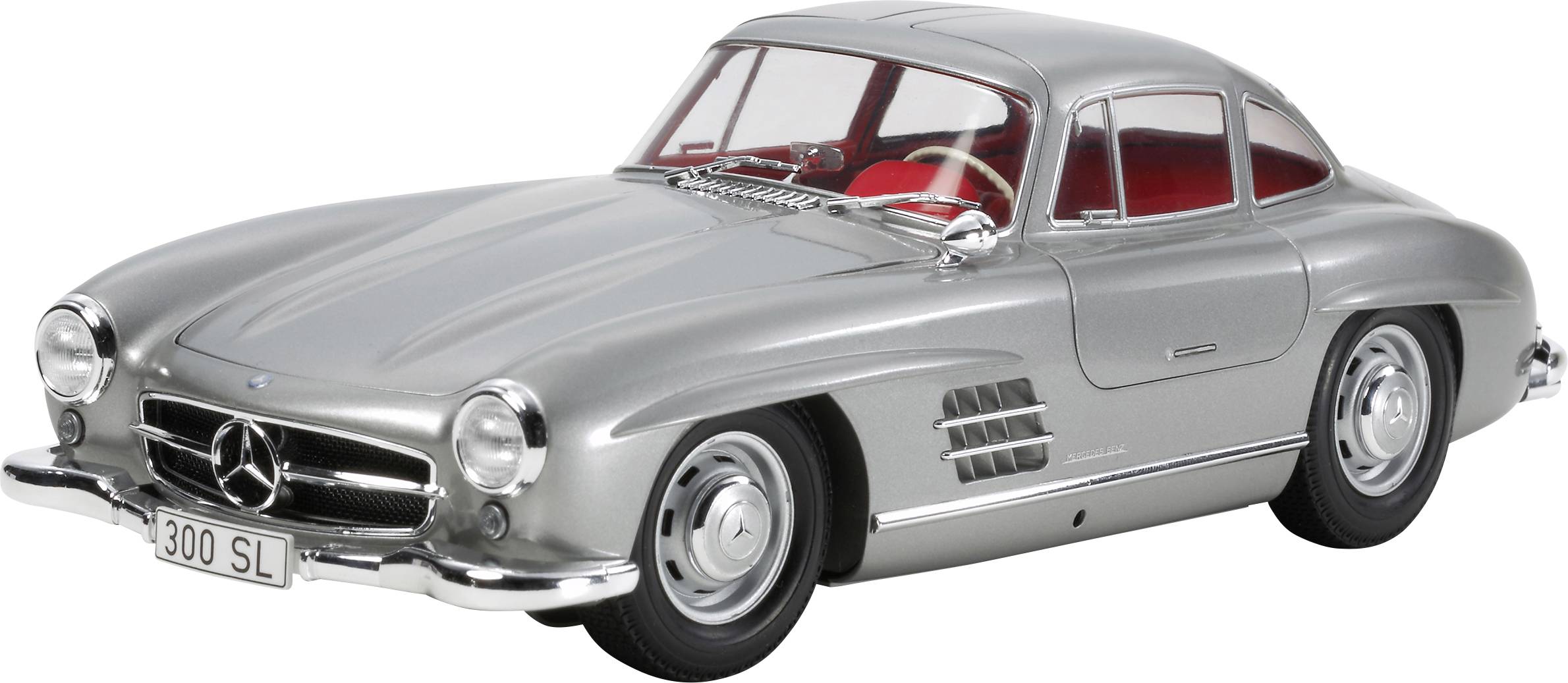 Silver Mercedes-Benz 300 SL with closed gull-wing doors, side view, on a white background.