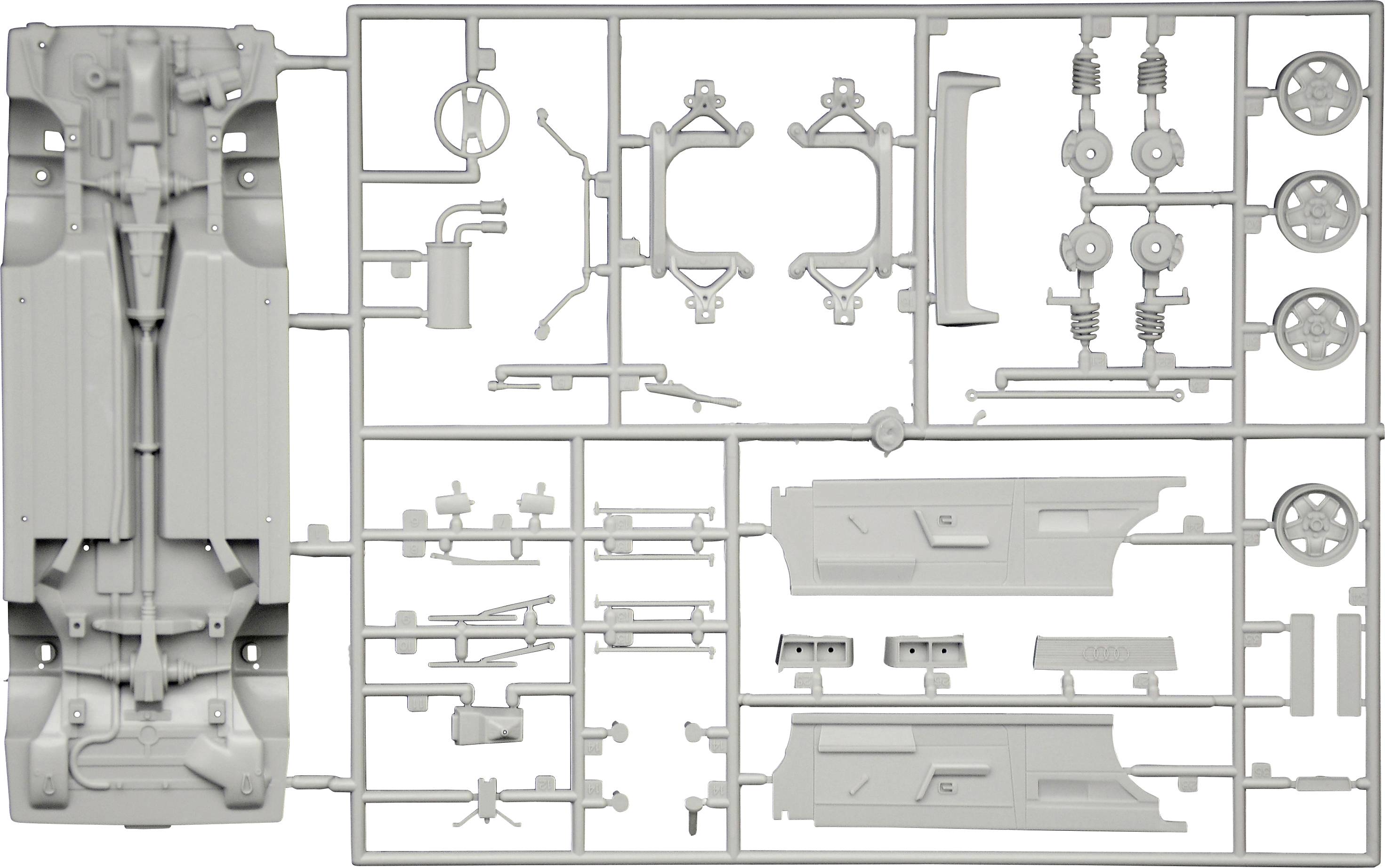 Plastic model car parts arranged in sprues, showing components such as wheels, chassis, and body parts.