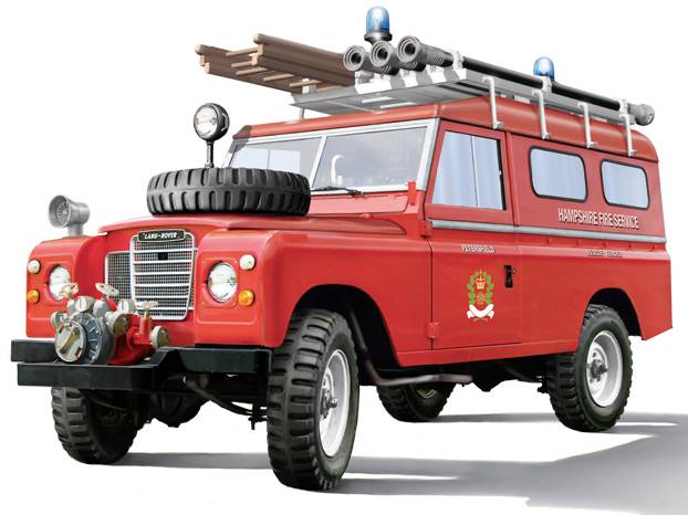 A red fire engine with ladders and equipment on the roof. On the side it reads 'Fire Service'. Vehicle from the 1960s.