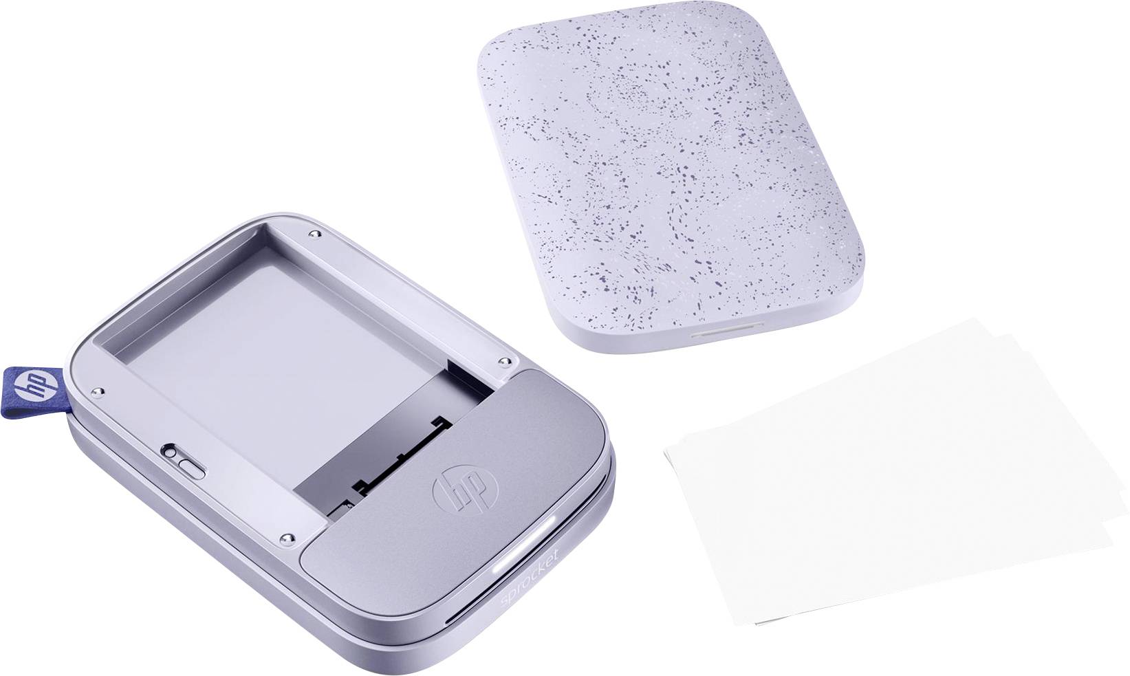 Portable photo printer with an open paper tray and removable cover, with four white photo papers beside it.