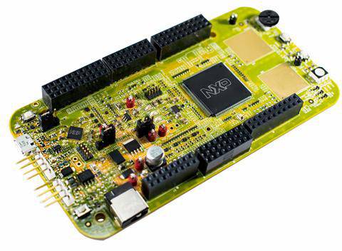 A green circuit board with various electronic components and a large chip in the centre, marked with 'NXP'.
