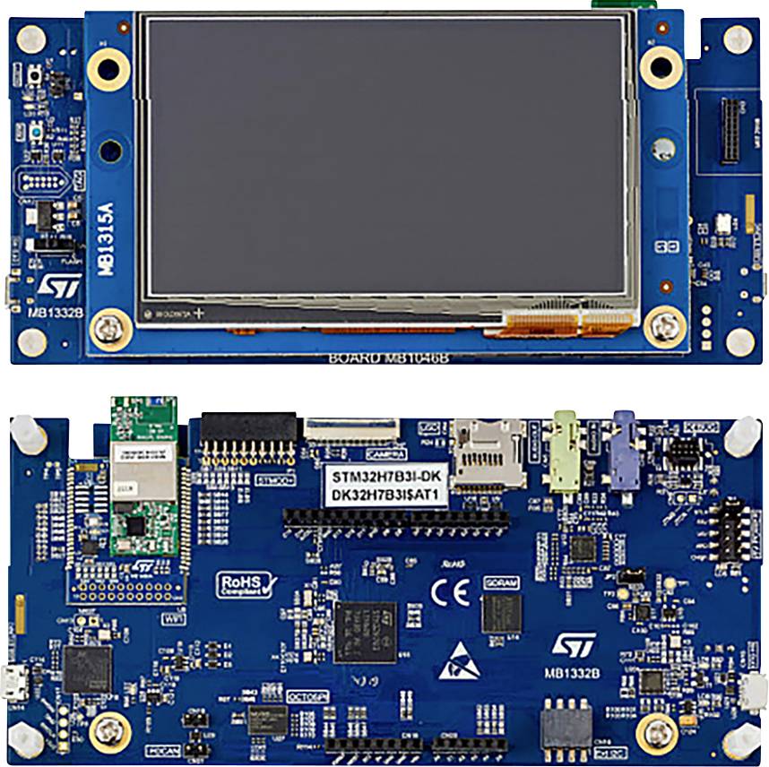 A microcontroller development board with a blue PCB and LCD display on top. Numerous ports and components are visible.