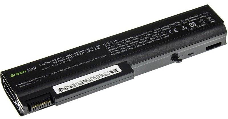 A rectangular laptop battery displays the inscription 'Green Cell' along with technical specifications and safety warnings.