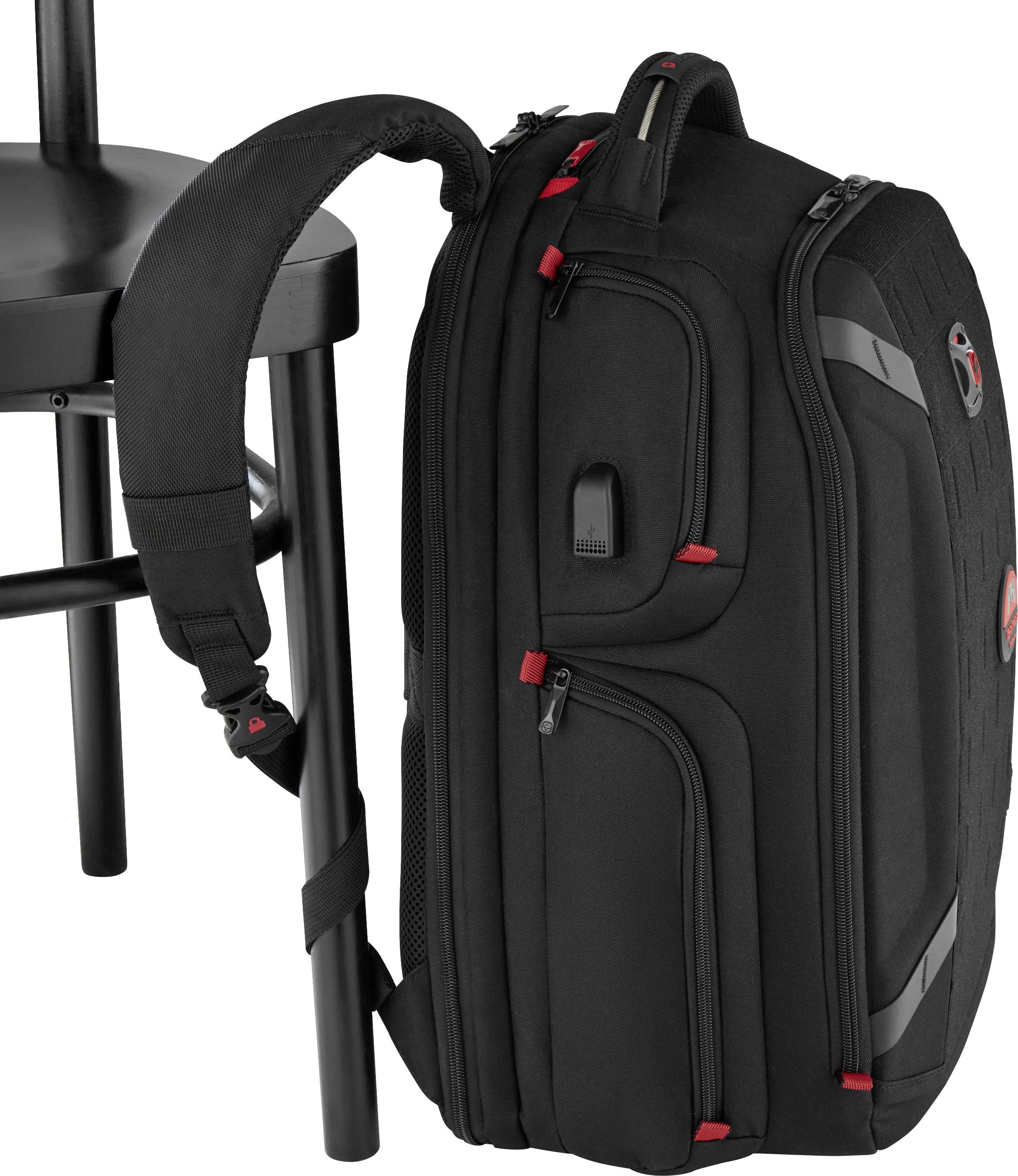 Black rucksack with red accents, attached to a black chair. Ergonomic design with multiple zip pockets.