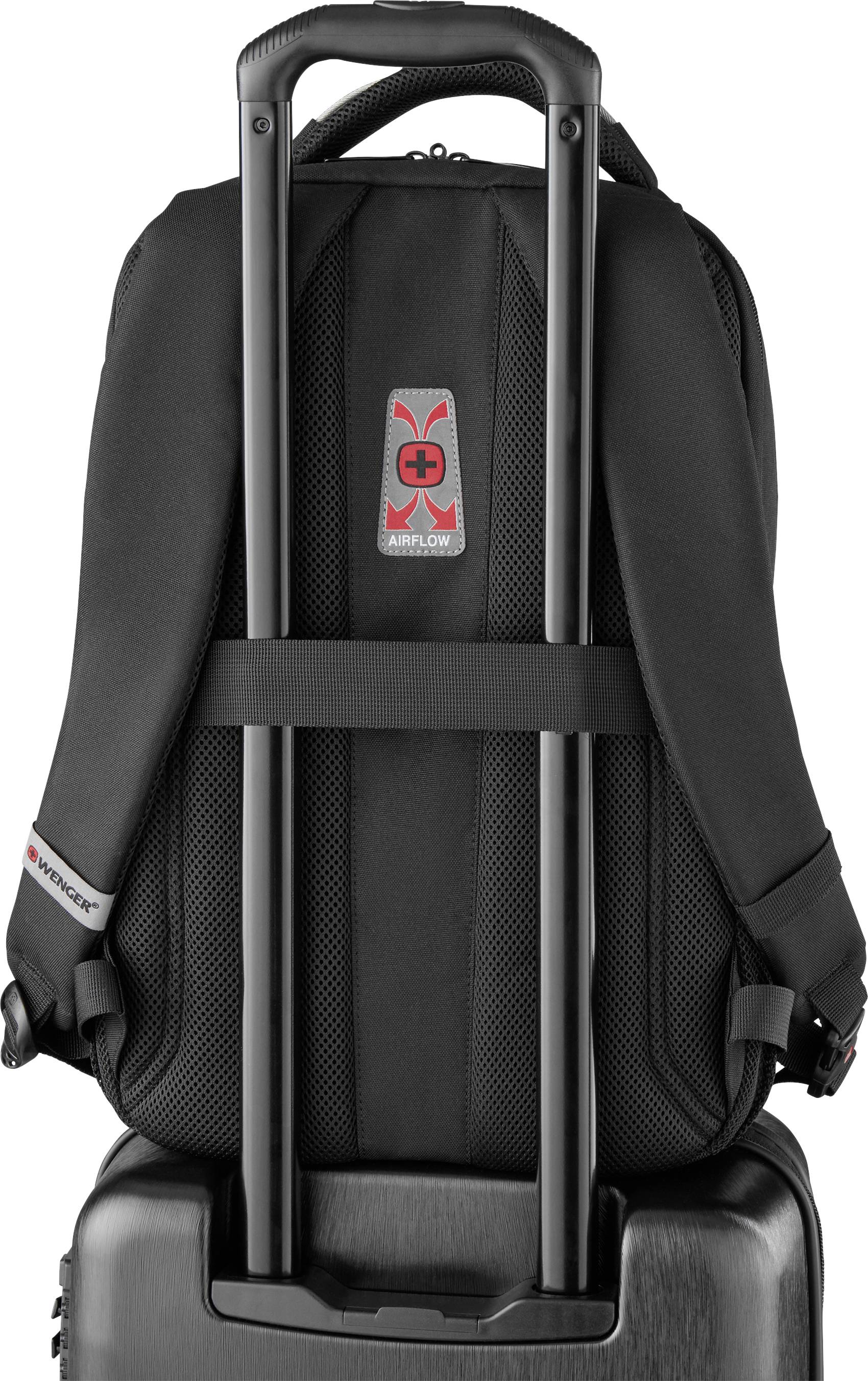 Rucksack attached to a black hard-shell suitcase on a trolley handle. Demonstrates carrying comfort through padding and airflow system.