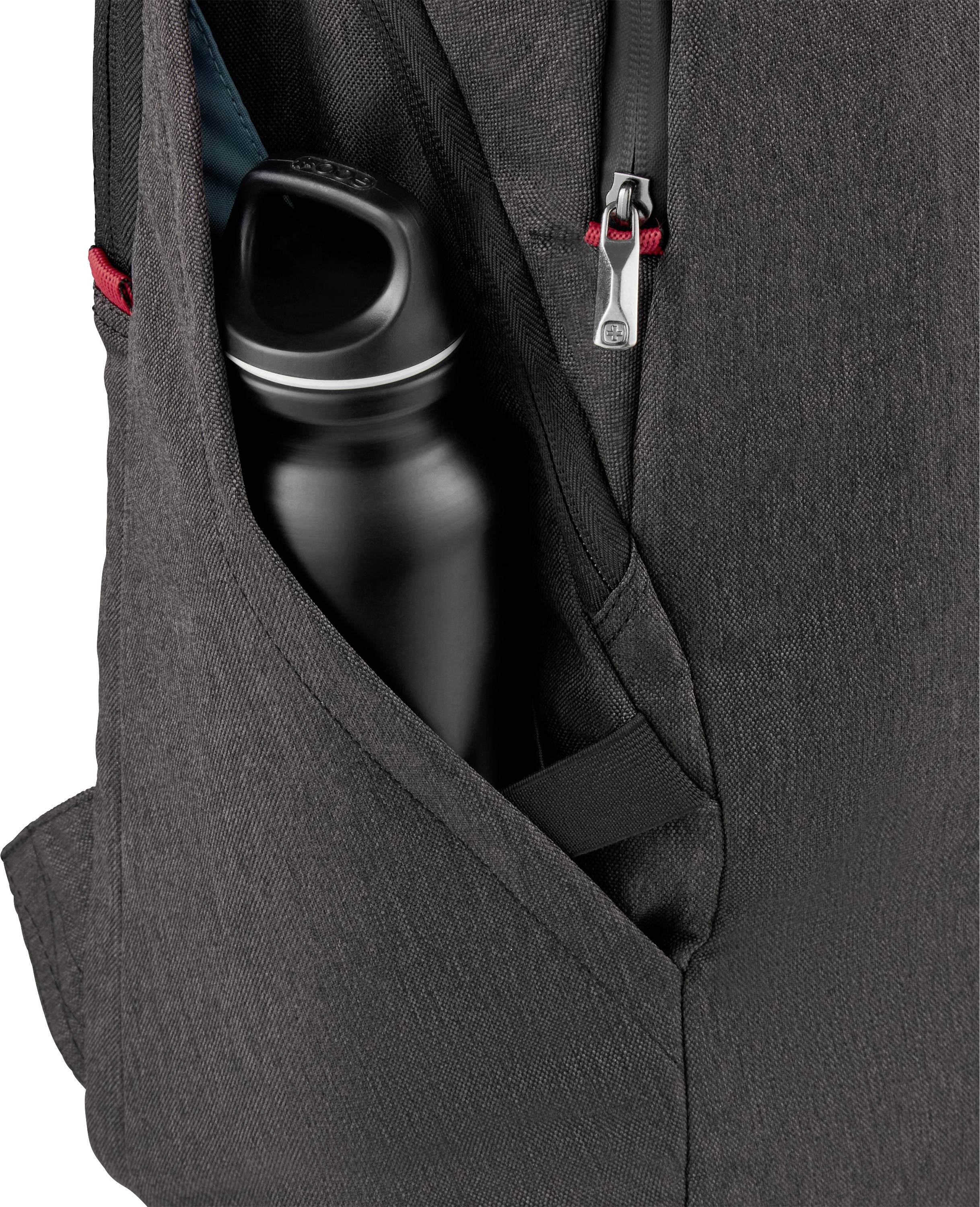Black drinking bottle in the outer pocket of a grey rucksack; zip open, bottle ready to be taken out.
