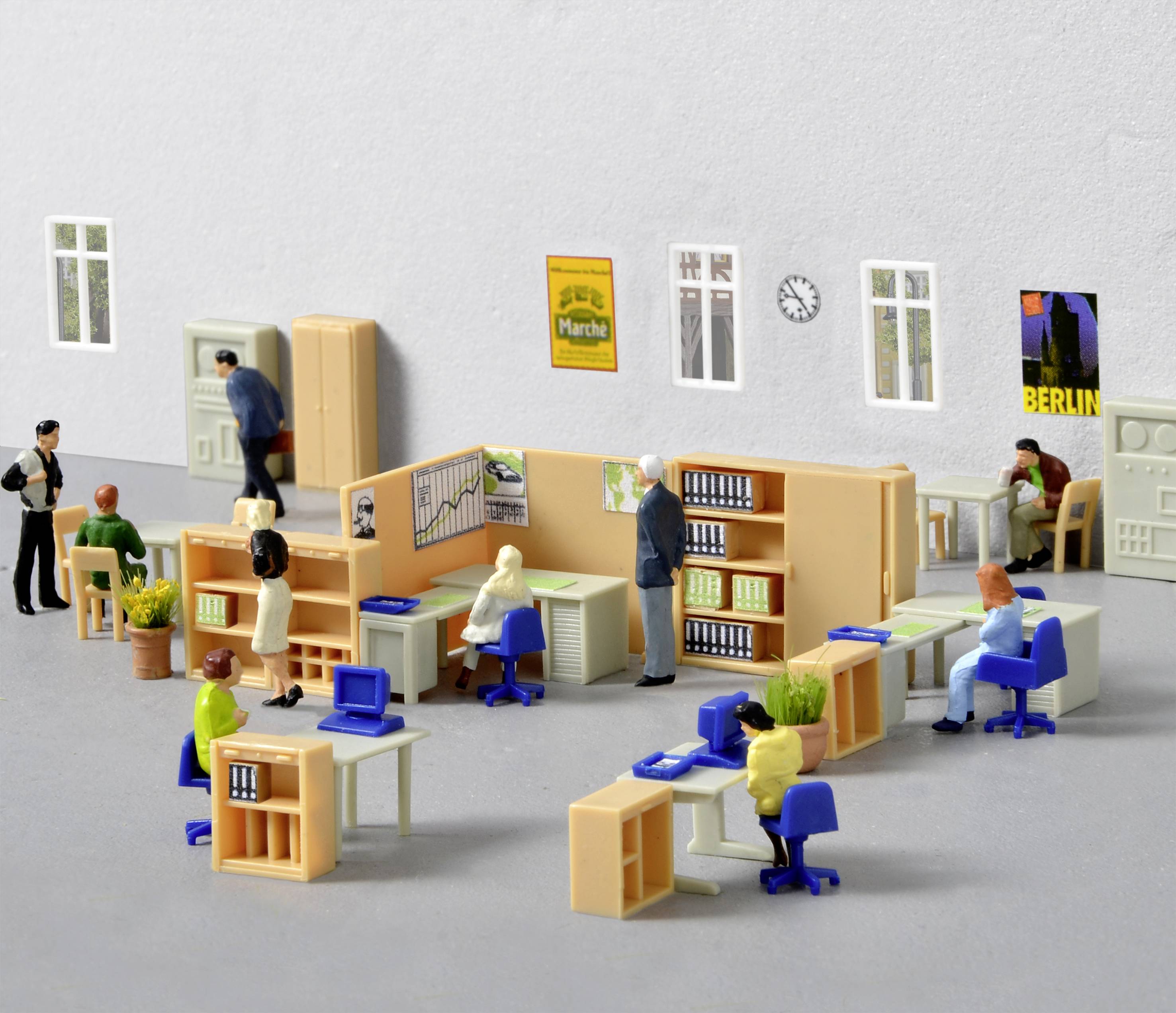 A miniature scene in an office shows people working at desks, shelves with files, and a clock on the wall.