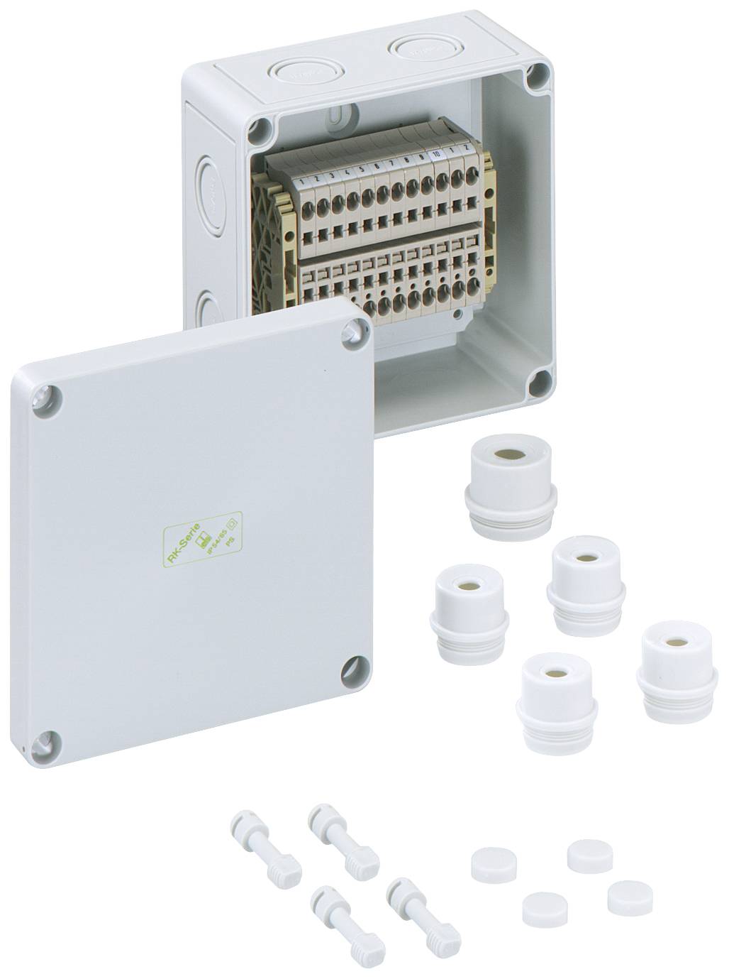 Rectangular distribution box in shades of grey with a removable lid, with row connections visible inside. Accessory parts positioned beside it.