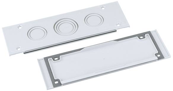Two white plastic parts, with a circular pattern on top, rectangular and smooth at the bottom. They appear to be designed to fit together.