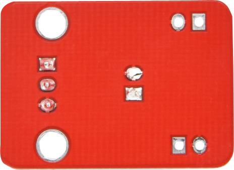 Red electronic circuit board with multiple small soldering points and components, rectangular shape, holes at the corners.