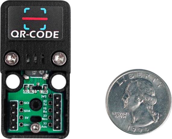 A QR code scanner module is placed next to a coin for scale reference.