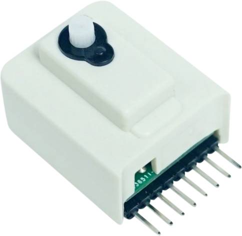 A white electronic sensor with multiple metal pins on the underside and a round, black control element on top.