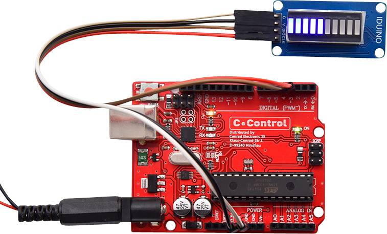 A circuit board (C-Control) connected to a blue LED display via cables. Main components and connections visible.
