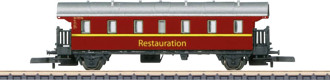 A red dining car with the inscription 'Restauration' on a railway track, side view.