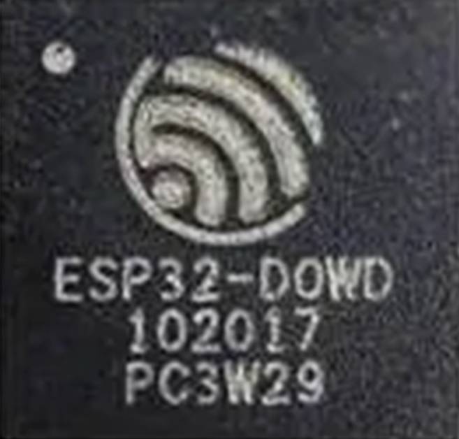 Close-up of a microcontroller with the inscription 'ESP32-D0WD 102017 PC3W29' and a circular, spiral-shaped logo on top.