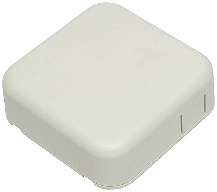 A square, white plastic device with rounded corners and ventilation slots. Could serve as a router or electronic device.