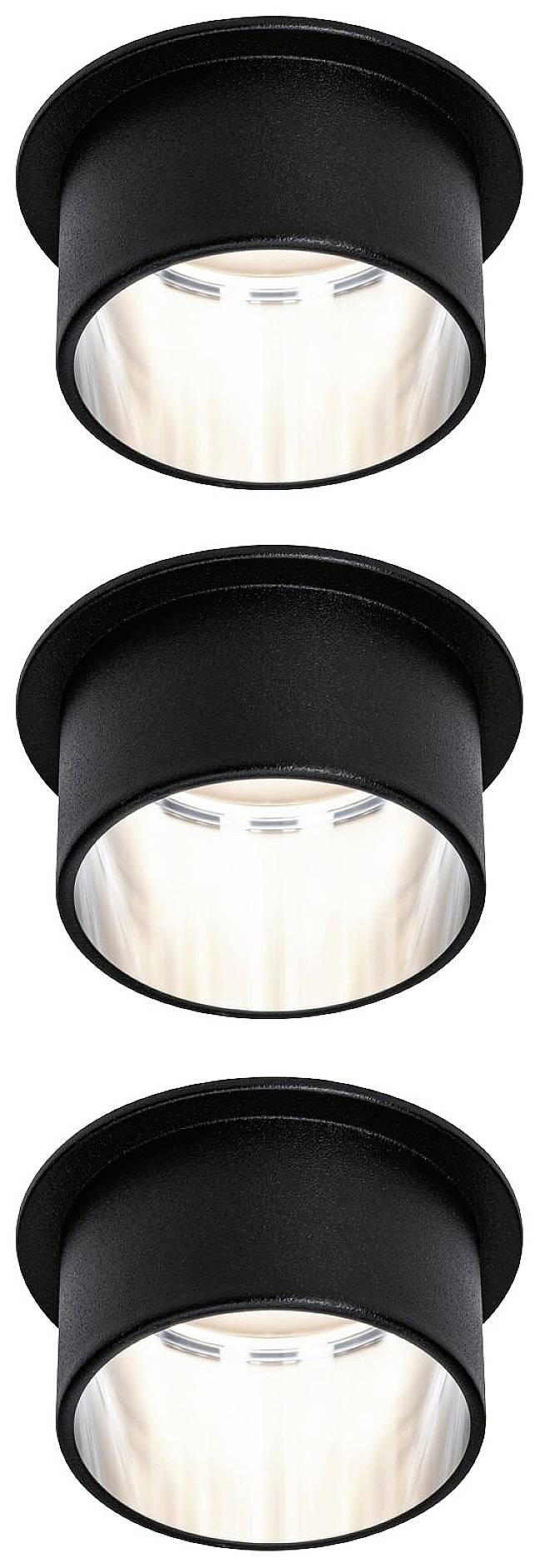 Three black, cylindrical ceiling spotlights are arranged evenly, casting light downwards.