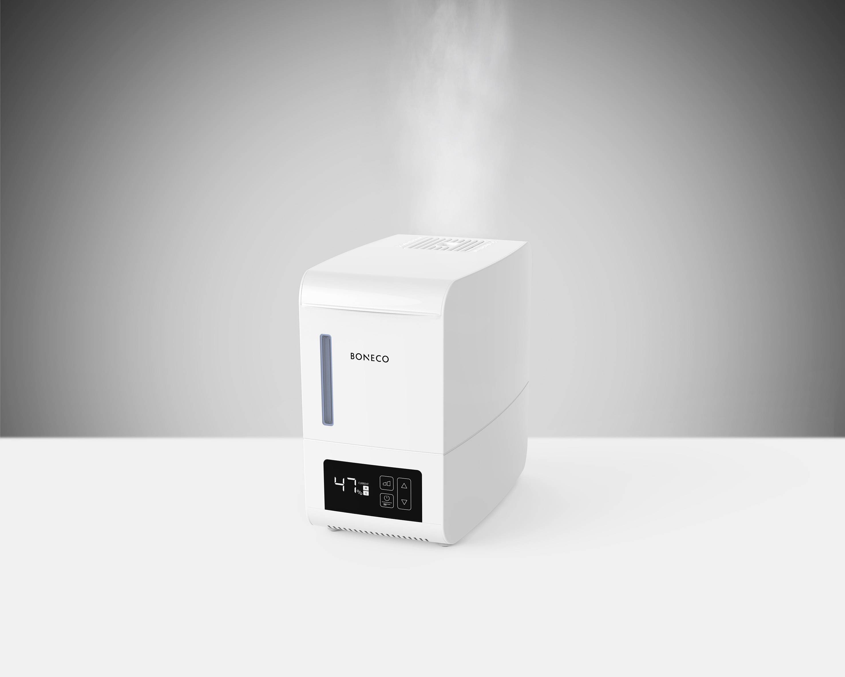 A white air humidifier on a table, displaying a digital reading of '47%' humidity and emitting steam, against a grey background.