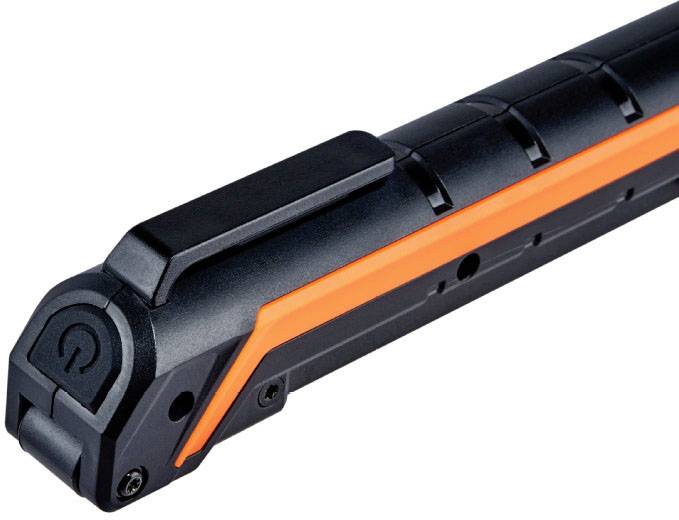 A black, battery-powered device with an orange stripe and an on/off button, possibly a bicycle light.