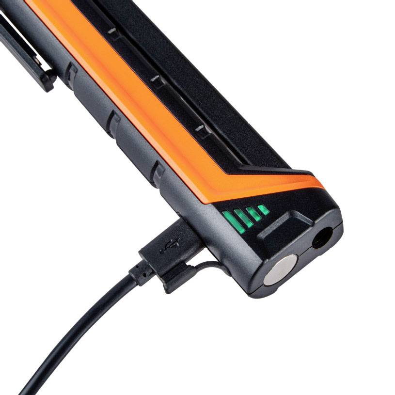 A black device with an orange stripe and USB port, likely a portable charger or power bank.