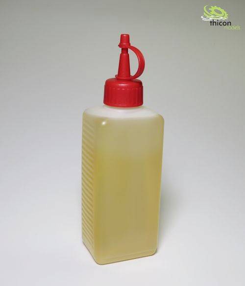 Clear plastic bottle with a red screw cap and dispensing valve, filled with yellow liquid.