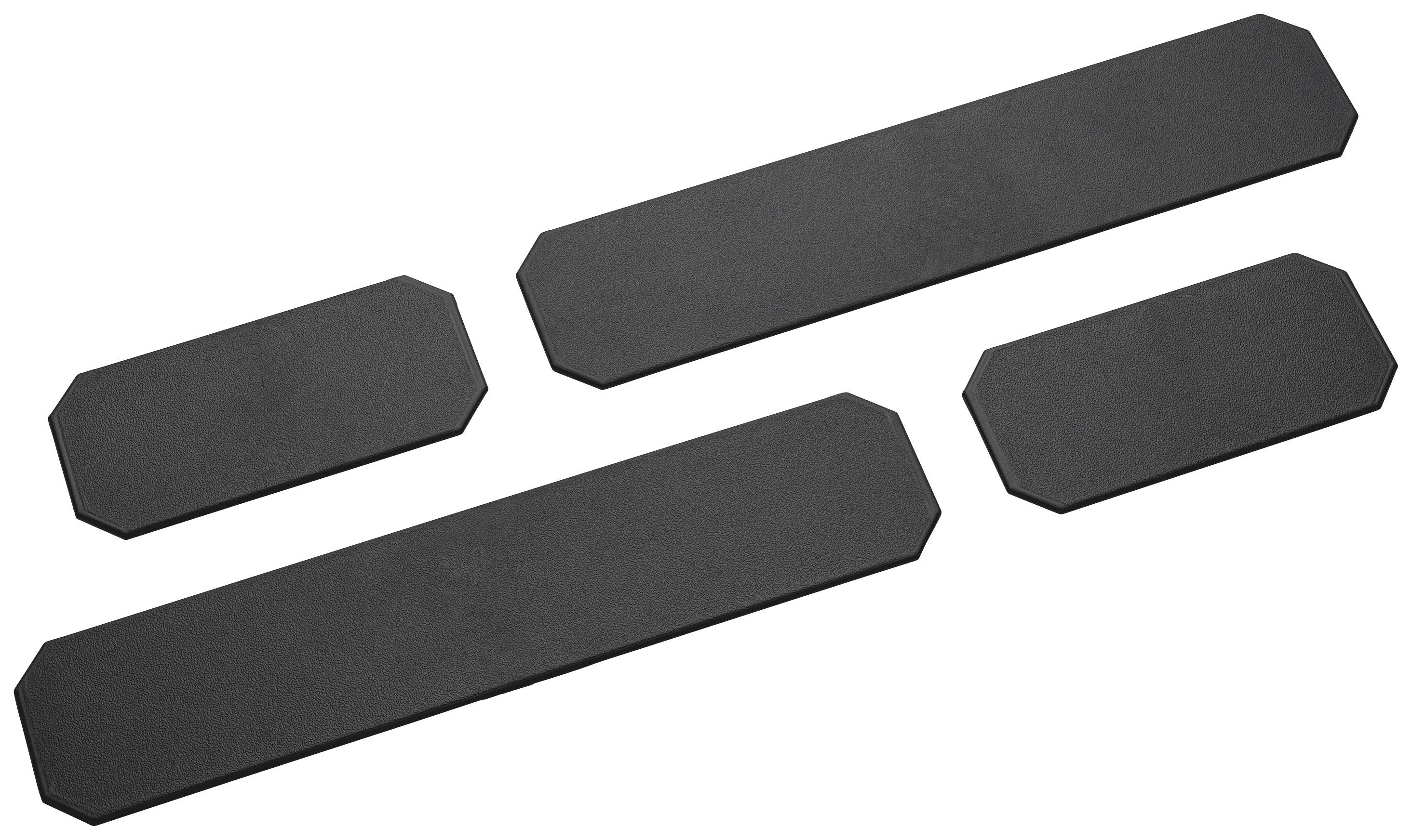 Four black, rectangular rubber mats in different sizes, for non-slip surfaces or surface applications.