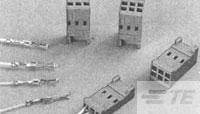 Several grey connectors of different sizes and shapes on a surface, some lying down, others standing upright.
