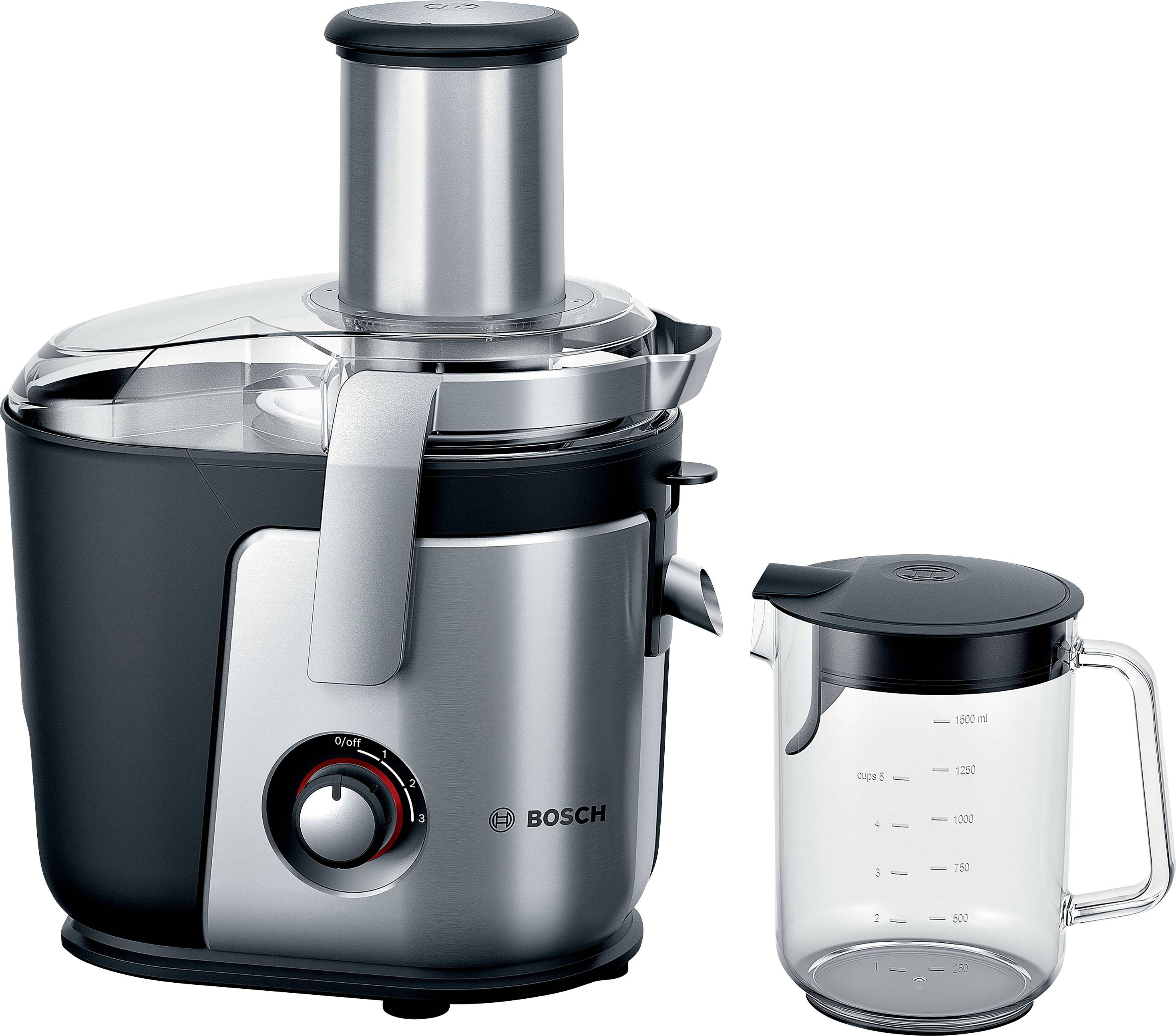 Stainless steel juicer with a large feeding chute and a measuring jug beside it.