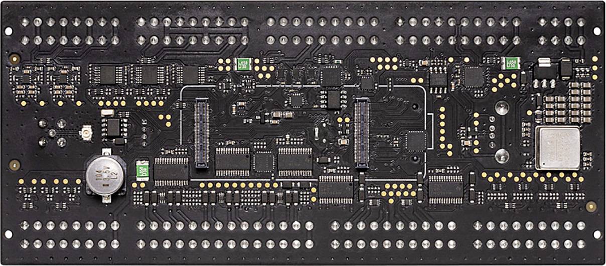 A black circuit board with numerous electronic components, chips, and slots, likely for computer-controlled applications.