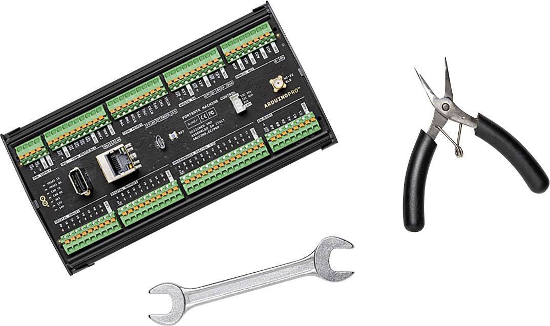 An electronic circuit board with numerous ports, alongside a pair of pliers and a spanner, set against a white background.