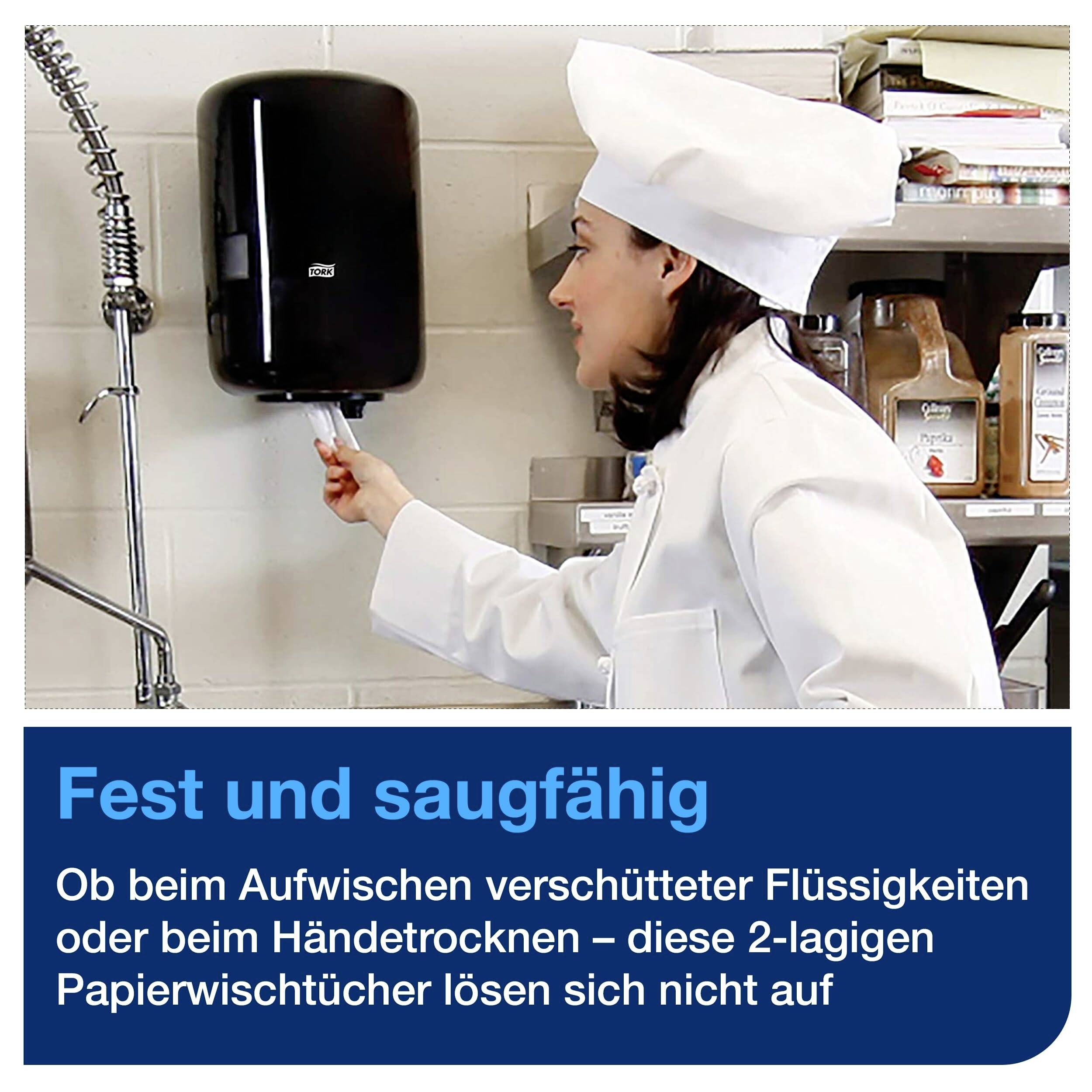 Female chef removes paper towel from dispenser. Text: 'Strong and absorbent'. Recommended for wiping and hand drying.