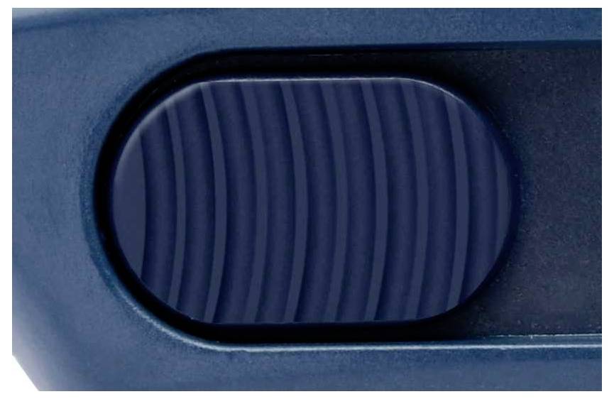 A blue, ribbed button on a device.