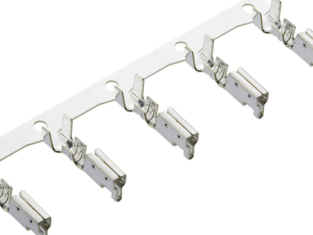 A row of five metallic connectors on a strip used for electrical applications.