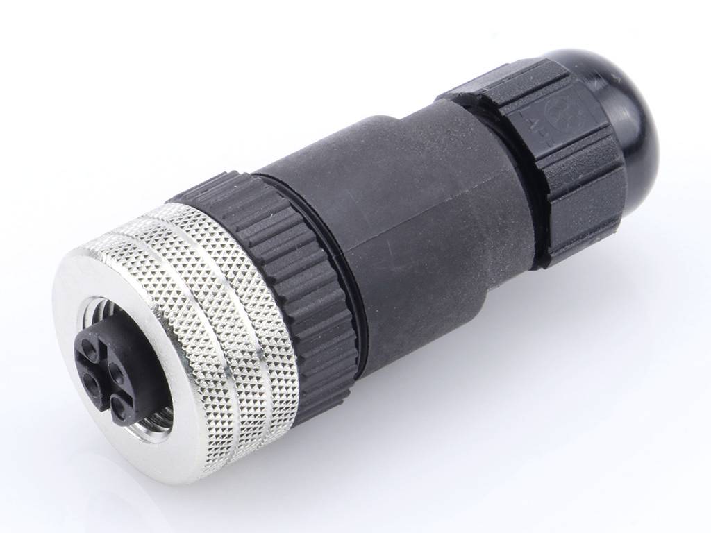 A black connector with a metal thread is lying on a white surface.