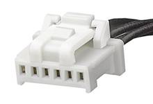 A white electronic plug connector with multiple pins, connected to a black cable, on a neutral background.