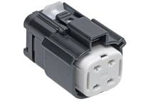 A black, rectangular plastic plug with white pins, suitable for technical connections, on a white background.